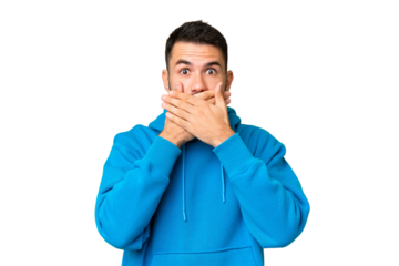 Young handsome caucasian man over isolated chroma key background covering mouth with hands