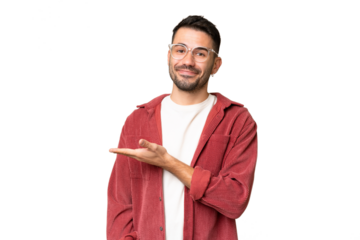 Young handsome caucasian man over isolated chroma key background presenting an idea while looking smiling towards