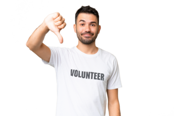 Young volunteer caucasian man over isolated chroma key background showing thumb down with negative expression