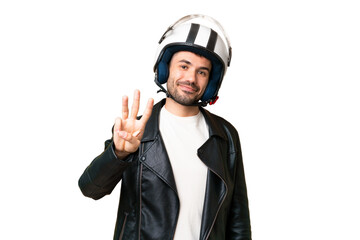 Young caucasian man with a motorcycle helmet over isolated chroma key background happy and counting three with fingers