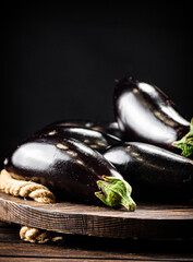Ripe eggplant on a wooden tray. 