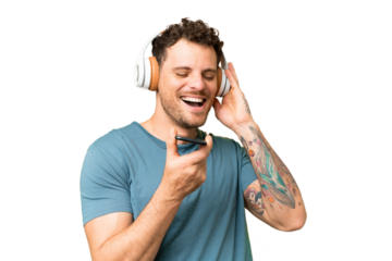Brazilian man over isolated chroma key background listening music with a mobile and singing