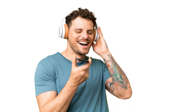 Brazilian man over isolated chroma key background listening music with a mobile and singing