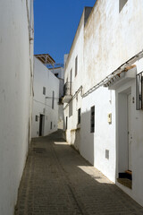 Fototapeta na wymiar Beautiful street in the historical center of the white beautiful village of Vejer de la Frontera in a sunny day, Cadiz province, Andalusia, Spain