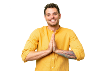 Brazilian man over isolated chroma key background keeps palm together. Person asks for something
