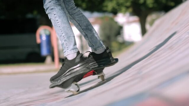 Legs on waveboard close up, Girl riding on casterboard with two wheels, modern street skate sports of teenagers, ripstick for balance ride.