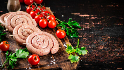 Round raw sausages with tomatoes and parsley. 