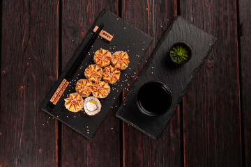 Sushi roll philadelphia with crab avocado and cream cheese on black background top view. Sushi menu. Japanese food concept