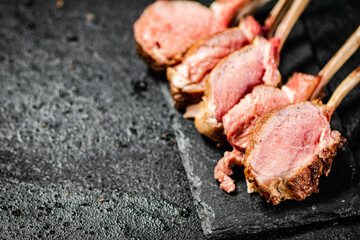 Rack lamb grill on a stone board. 