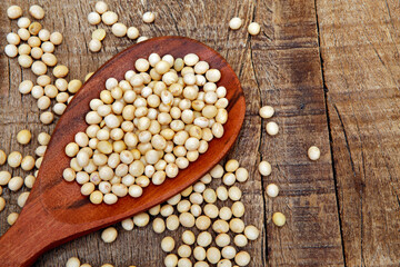 Soya beans on wooden spoon. Rustic table. Brazil. Space for text
