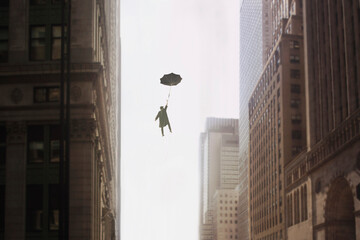 surreal man with umbrella flies into the sky between the buildings of a metropolis