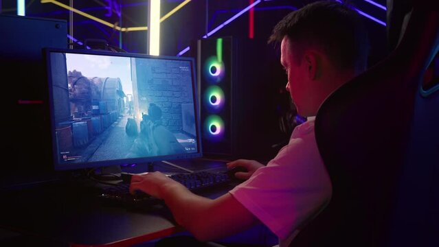 Gamer enjoying digital entertainment by playing modern warfare simulator. Gamer with digital entertainment hobby completing a game level. Gamer killing npc in a digital entertainment battle mission.