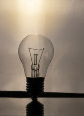 A tungsten light bulb on a smoky background. power outage concept