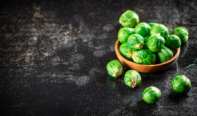 Fresh Brussels cabbage in a wooden plate. 