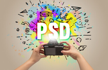 Close-up of a hand holding digital camera with abstract drawing