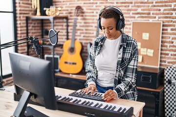 African american woman musician having dj session at music studio
