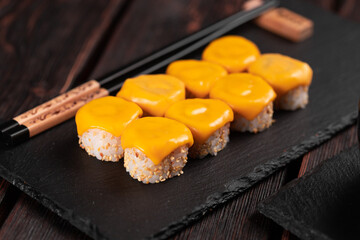 Sushi roll with cheese with chopsticks - asian Japanese food concept