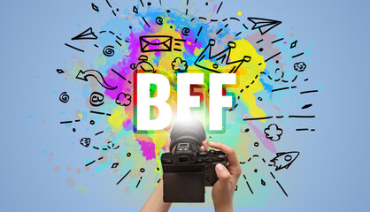 Close-up of a hand holding digital camera with abstract drawing