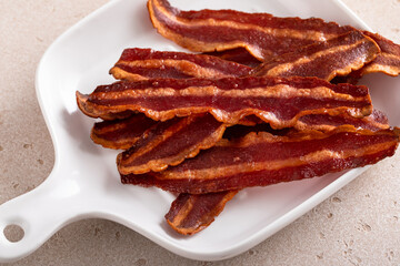 Turkey bacon cooked on a white plate iron pan