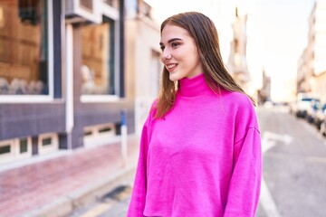 Young woman smiling confident looking to the side at street