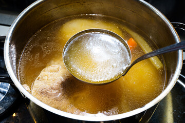 pot with ladle full of meat broth - obrazy, fototapety, plakaty