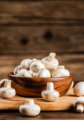 Mushrooms in a bowl on a cutting board. 