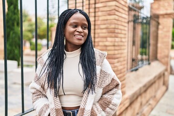 African american woman smiling confident looking to the side at street