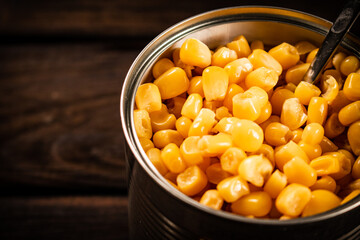 An open can of canned corn. 