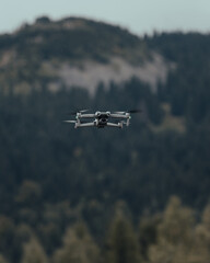 Fototapeta na wymiar drone soaring against the background of the mountains (selective focus)
