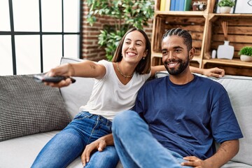Man and woman couple smiling confident watching tv at home