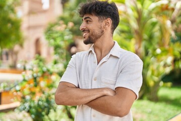 Young arab man smiling confident standing with arms crossed gesture at park