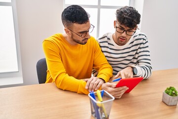 Two man business workers using touchpad working at office