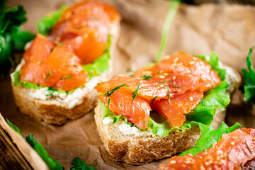 Salmon sandwich on paper. Macro background.