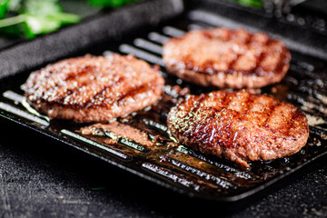 Grilled burger in a frying pan. 
