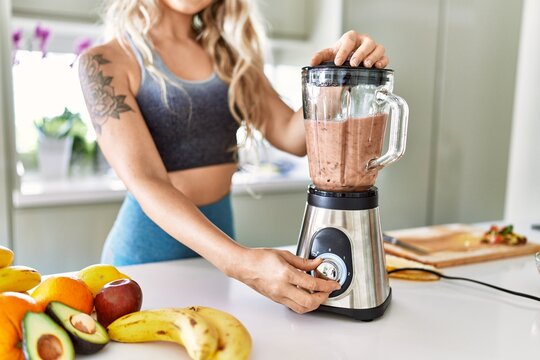 Young Woman Blending Healthy Smoothie At Kitchen