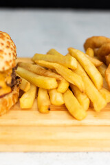 Burger cheese with potato in wooden table and black backgournd 