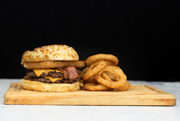 Burger cheese with potato in wooden table and black backgournd 