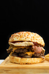Burger cheese with potato in wooden table and black backgournd 