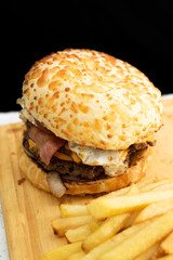 Burger cheese with potato in wooden table and black backgournd 