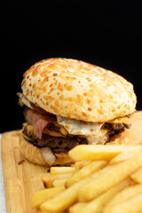 Burger cheese with potato in wooden table and black backgournd 
