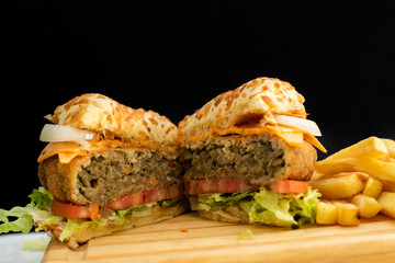 Burger cheese with potato in wooden table and black backgournd 