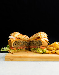 Burger cheese with potato in wooden table and black backgournd 