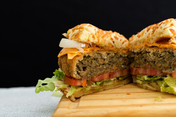 Burger cheese with potato in wooden table and black backgournd 
