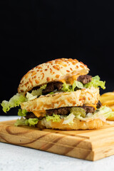 Burger cheese with potato in wooden table and black backgournd 