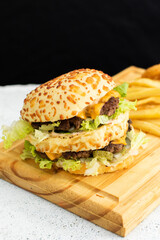 Burger cheese with potato in wooden table and black backgournd 