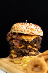 Burger cheese with potato in wooden table and black backgournd 
