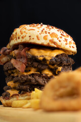 Burger cheese with potato in wooden table and black backgournd 