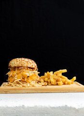 Burger cheese with potato in wooden table and black backgournd 