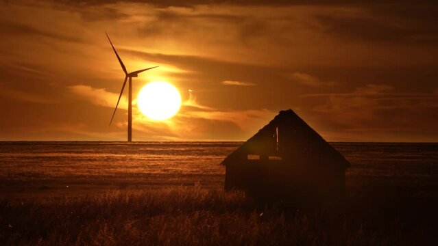 Wind turbine in rural New Mexico near Clovis with cabin.
