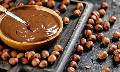 Hazelnut butter on a cutting board with a spoon. 
